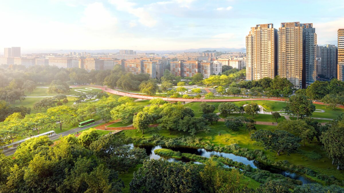 Luftfoto af grønt område i Singapore med højhuse i baggrunden.